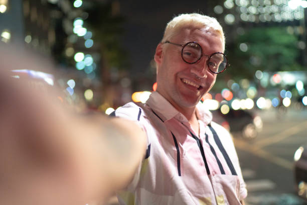 istock Man taking a selfie in the city at night 1152723986