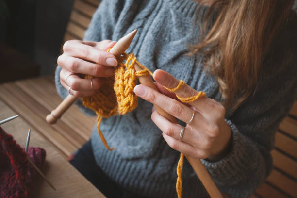 istock Close up on woman's hands knitting 1152724175