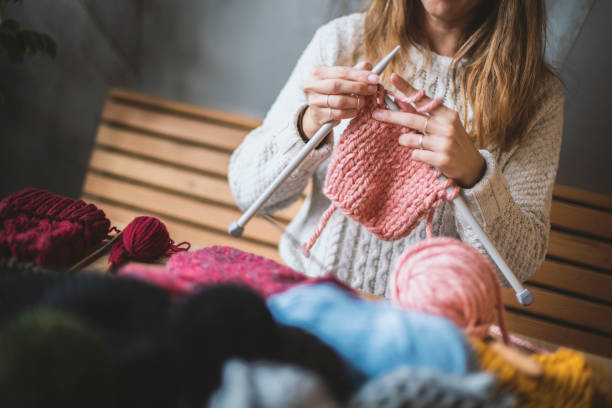 istock Close up on woman's hands knitting 1152724176