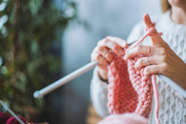istock Close up on woman's hands knitting 1152724184