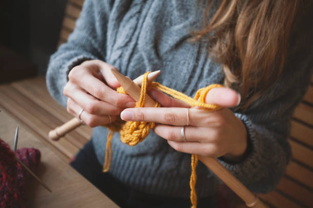 istock Close up on woman's hands knitting 1152724195