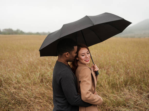 istock Engaged couple under an umbrella 1152725330