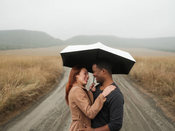 istock Loving young couple under an umbrella 1152726010