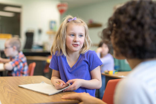 istock A first grade teacher talking with one of her students in the classroom 1152726150