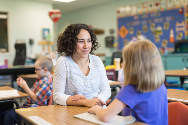istock A first grade teacher talking with one of her students in the classroom 1152726158