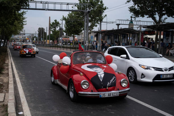 Izmir, Turkey - 100th anniversary of The day of Commemoration of Atatürk, Youth and Sports Day in Turkey. People celebrating the national day in the streets. A VW car decorated with balloons in Turkish flag colors.
