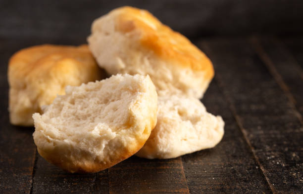 Homestyle Buttermilk Biscuits on a Rustic Wooden Table Homestyle Buttermilk Biscuits on a Rustic Wooden Table biscuit quick bread photos stock pictures, royalty-free photos & images