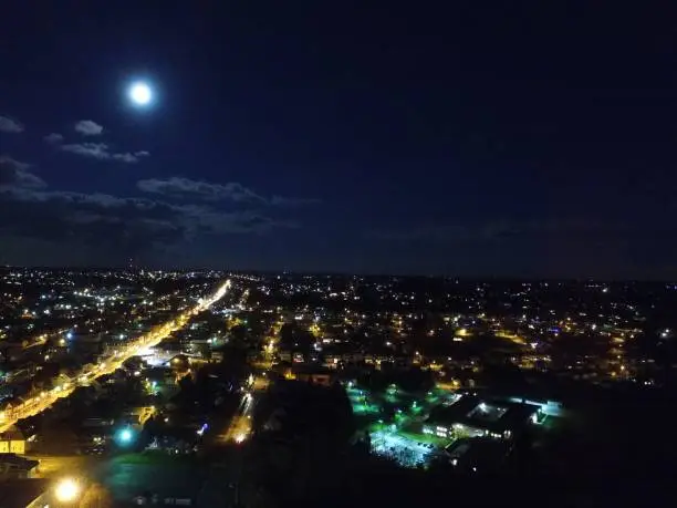 Vivid aerial shoot of suburban life with main street lights and full moon