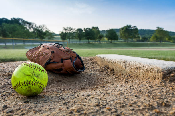 istock Softball and glove on pitchers mound on early morning springtime 1152731212
