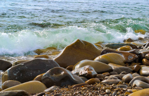 istock The sea waves rolling on the stony coast, a close up 1152731880