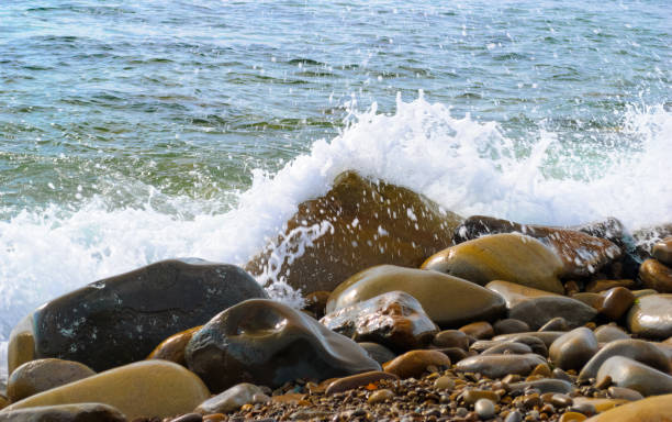 istock The sea waves rolling on the stony coast, a close up 1152731911