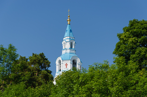 View of the bell tower of the Orthodox Cathedral framed by greenery.Spaso-Preobrazhensky Cathedral of the Valaam Monastery.