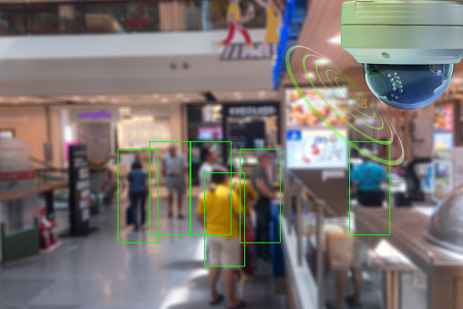 A Dome CCTV  infrared camera  technology 4.0 for look security area of people at shopping mall show signage with checking and courting people in green boxed security area