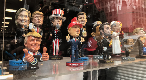 New York, 5/23/2019: Bobble head dolls of various political figures are seen on a gift shop's window display.