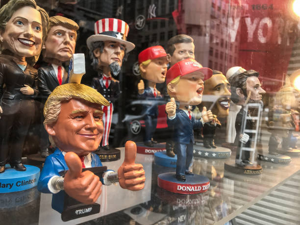 Satirical dolls of political figures at a souvenir shop window display New York, 5/23/2019: Bobble head dolls of various political figures are seen on a gift shop's window display. hillary clinton stock pictures, royalty-free photos & images