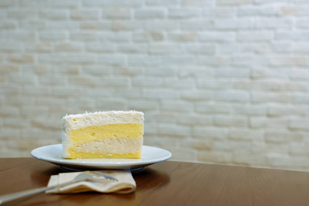 istock Coconut cake on a white plate in a coffee shop. 1152738406