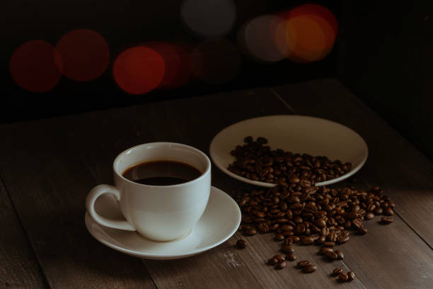 istock Coffee cup and coffee beans on black wooden background. 1152738465