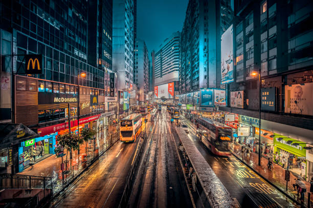 Hong Kong Causeway Bay in the rain at night Causeway Bay, Hong Kong - May 29, 2019 : Night view of crowded Hennessy Road in Causeway Bay. It is a famous shopping and dinning place in Hong Kong. causeway photos stock pictures, royalty-free photos & images