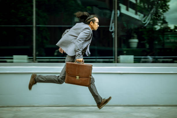 istock The man in the suit holds a leather bag. He running very speed. with motion action technical photography. 1152752549