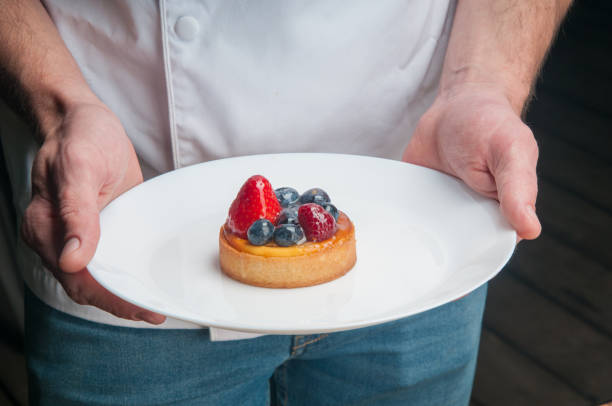 istock Restaurant chef holding plate with sweet dessert 1152753333