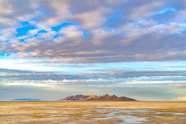 istock Panorama of a sandy lake shore under a blue sky filled with puffy clouds 1152757150