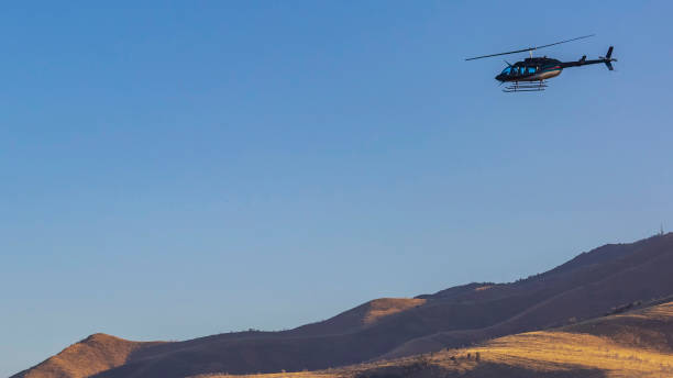 istock Panorama frame Helicopter flying over an immense mountain with clear blue sky background 1152757228