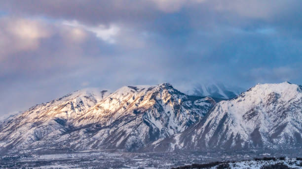 istock Panorama Majestic mountain covered with snow under blue sky with gray puffy clouds 1152757239