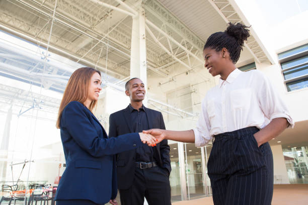istock Happy successful businesswomen shaking hands 1152757584