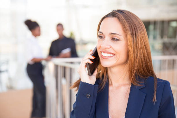 istock Happy cheerful business lady speaking on cellphone 1152757592