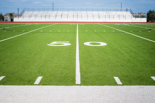 50 yard line on empty American football field stadium