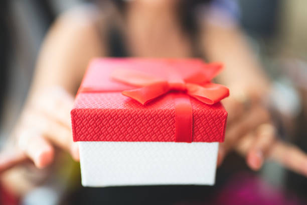 istock woman holding a  gift box 1152758620