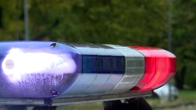 A police car is flashing. Red and blue lights and sirens.