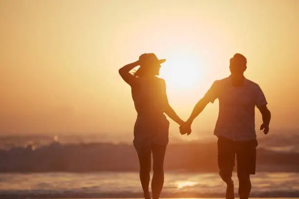 Rearview shot of a mature couple spending quality time on the beach