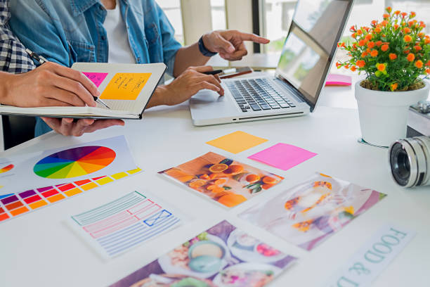 istock Asian advertising designer creative start-up team discussing ideas in office. 1152764345