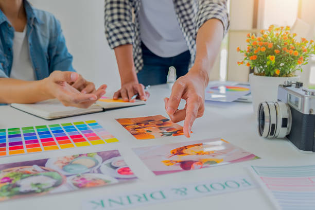 istock Asian advertising designer creative start-up team discussing ideas in office. 1152764351