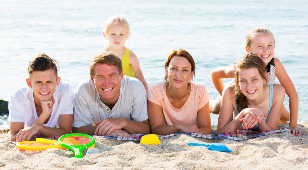 istock Smiling family on sandy beach 1152766495