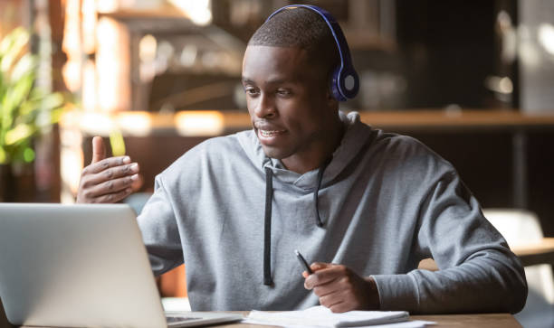 african american man in headphones making video call in cafe - adult black camera caucasian imagens e fotografias de stock