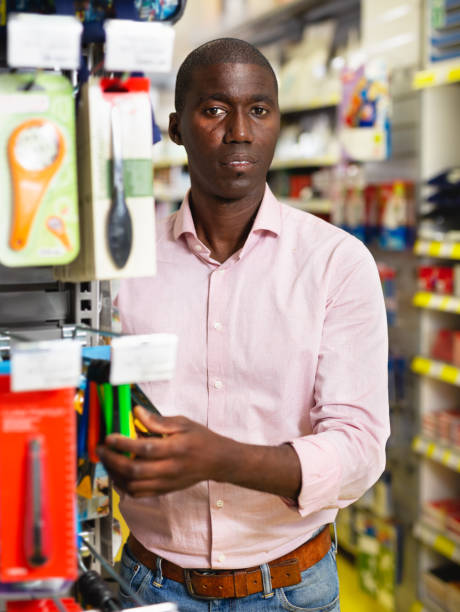 istock Man customer choosing different stationery knifes 1152768943