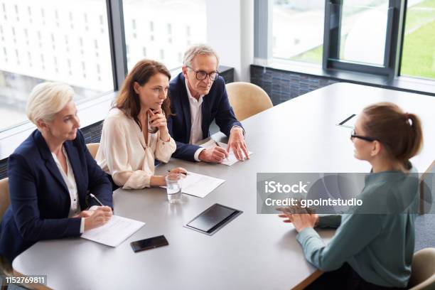 Woman During Job Interview And Three Elegant Members Of Management Stock Photo - Download Image Now