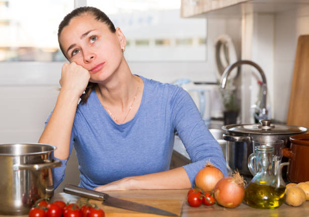 istock Sad tired young woman in the kitchen 1152772638