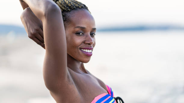 istock African woman having fun at the beach 1152772986