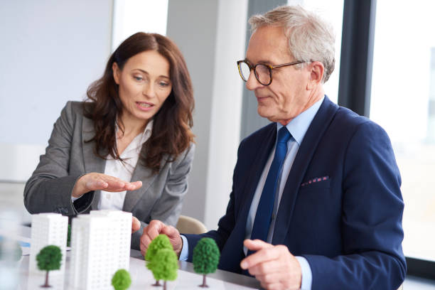 istock Business couple over architectural model 1152773156