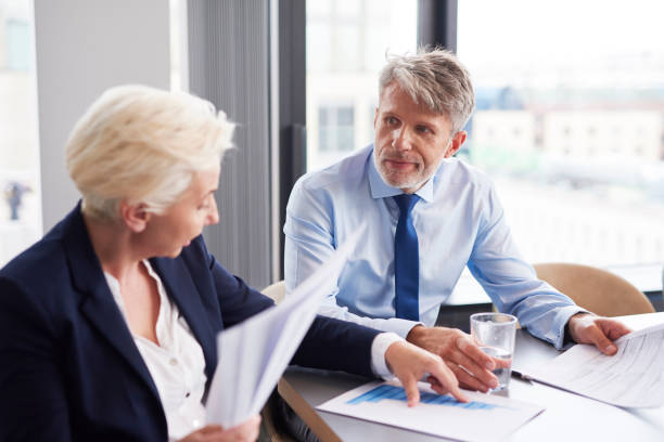 istock Business couple analyzing the charts 1152773328
