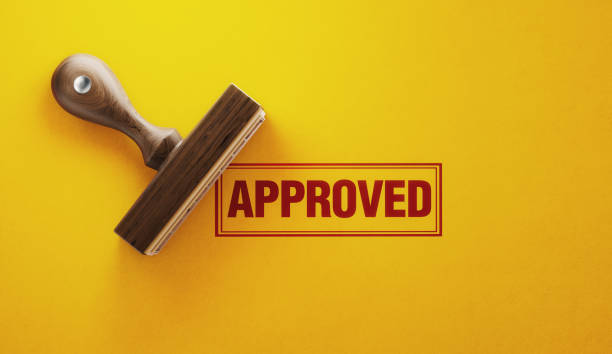Wooden Approved Stamp On Yellow Background Wooden approved stamp on yellow background. Horizontal composition with copy space. validation photos stock pictures, royalty-free photos & images