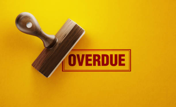 Wooden Overdue Stamp On Yellow Background Wooden overdue stamp on yellow background. Horizontal composition with copy space. past due stock pictures, royalty-free photos & images