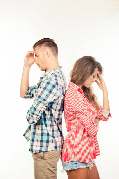 istock Young couple standing back to back ignoring each other 1152778033