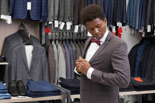 istock Client of boutiwue dressing suit, looking at jacket. 1152779019