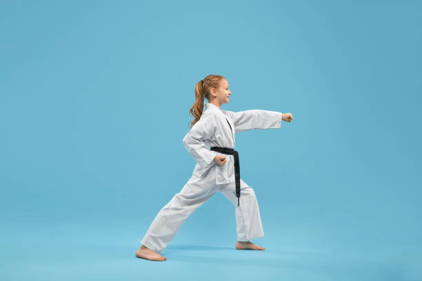 istock Karate girl with black belt practicing martial arts. 1152779026