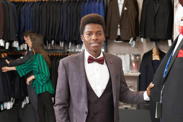 istock Handsome man in suit posing in boutique. 1152779037