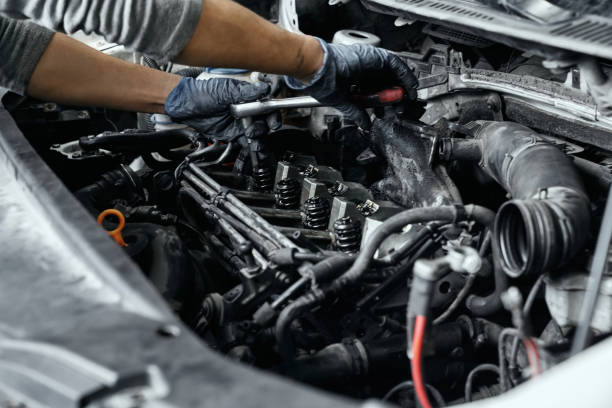 istock Close up of man's hands using wrench to remove spark plugs 1152779115